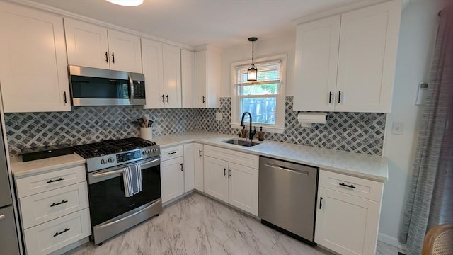 3 Bennett St, Hudson, MA 01749 - kitchen featuring stainless steel appliances, a sink, light marble finish flooring, white cabinets, and decorative backsplash