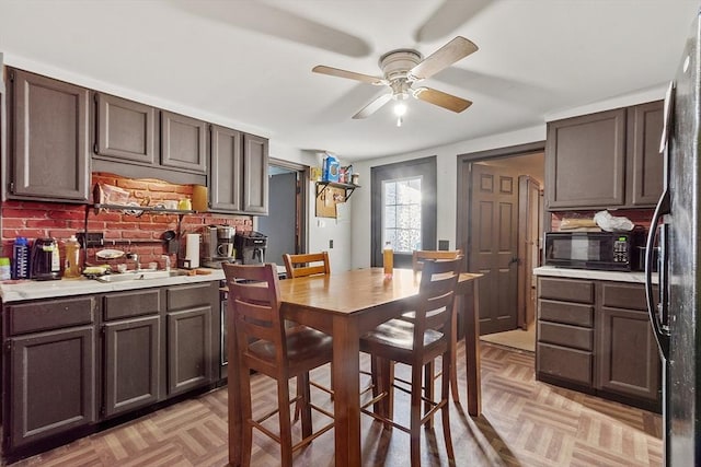 dining area with ceiling fan and light parquet flooring