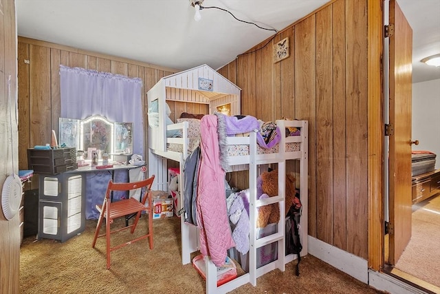 bedroom featuring carpet and wood walls