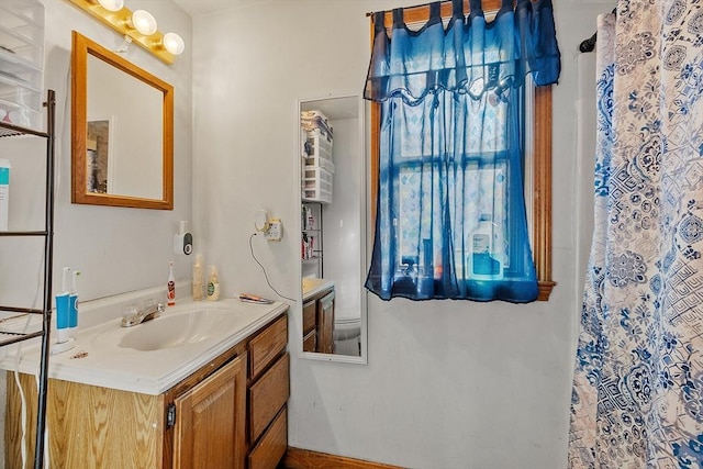 bathroom featuring curtained shower and vanity