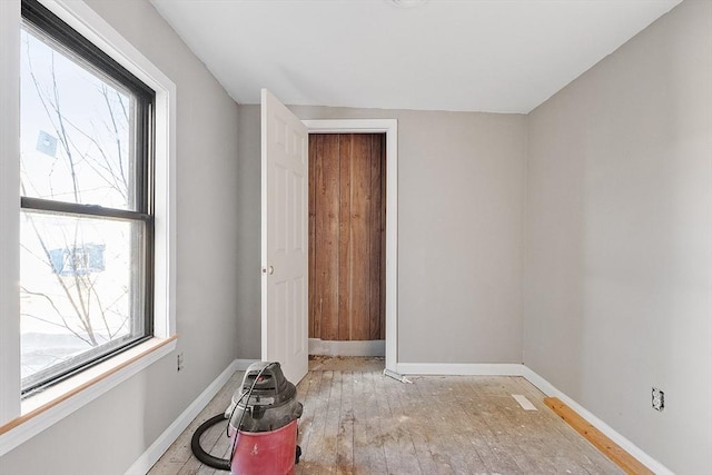 unfurnished room featuring light hardwood / wood-style flooring and plenty of natural light