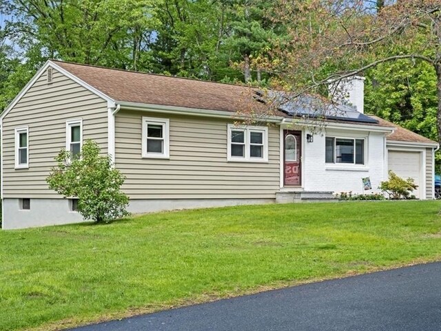 9 Lillian Rd, Acton, MA 01720 - ranch-style home with a chimney, a front yard, roof mounted solar panels, and a garage