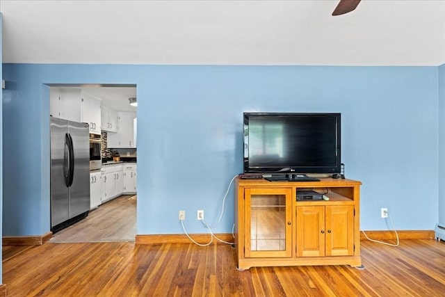 9 Lillian Rd, Acton, MA 01720 - living room with light wood-type flooring, baseboards, and a ceiling fan