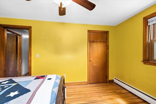 9 Lillian Rd, Acton, MA 01720 - bedroom featuring a baseboard heating unit, light wood-style flooring, baseboards, and ceiling fan