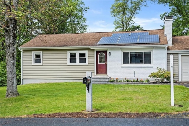 9 Lillian Rd, Acton, MA 01720 - view of front facade featuring solar panels, a chimney, a front yard, and a shingled roof