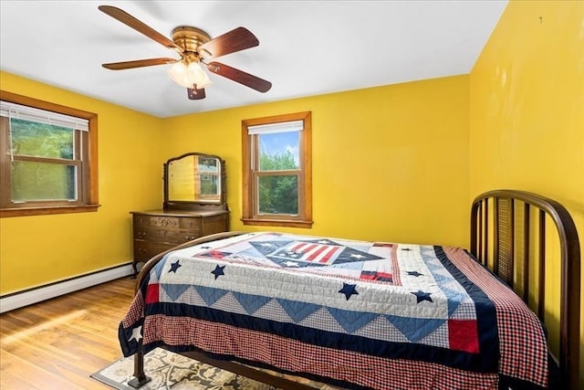 9 Lillian Rd, Acton, MA 01720 - bedroom featuring wood finished floors, a baseboard radiator, baseboards, and a ceiling fan