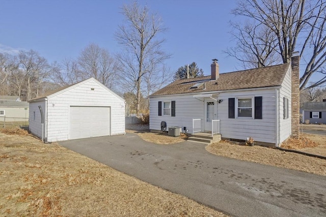 view of front of house with an outbuilding, central air condition unit, and a garage