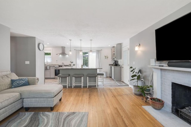 853 Sandwich, Falmouth, MA 02536 - living area with light wood-type flooring and a brick fireplace