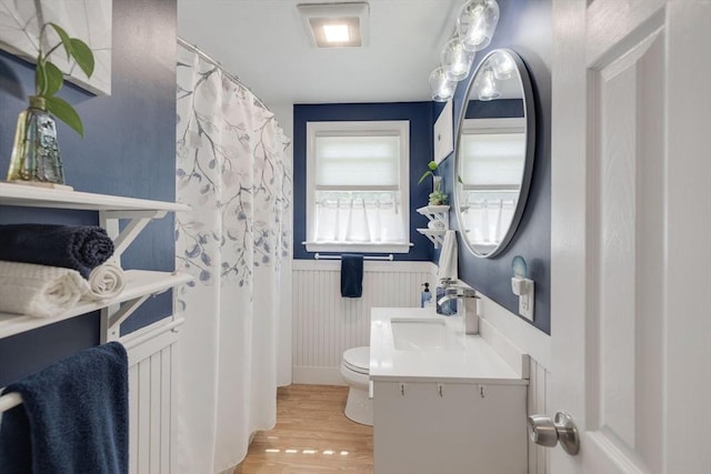 853 Sandwich, Falmouth, MA 02536 - full bath featuring wainscoting, wood finished floors, toilet, and vanity