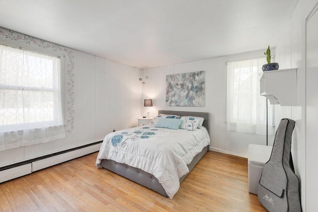 853 Sandwich, Falmouth, MA 02536 - bedroom featuring baseboard heating, wood finished floors, and multiple windows