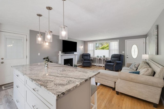 853 Sandwich, Falmouth, MA 02536 - kitchen with a baseboard radiator, open floor plan, and light wood finished floors