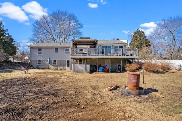 back of property featuring a chimney and a wooden deck