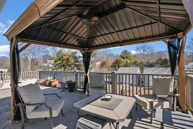 view of patio / terrace featuring a gazebo, a ceiling fan, and a deck