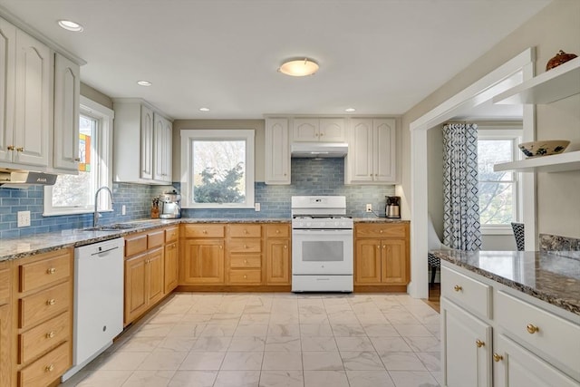 kitchen with stone countertops, tasteful backsplash, sink, light brown cabinets, and white appliances