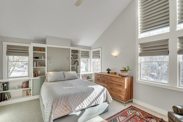 bedroom with carpet flooring and high vaulted ceiling