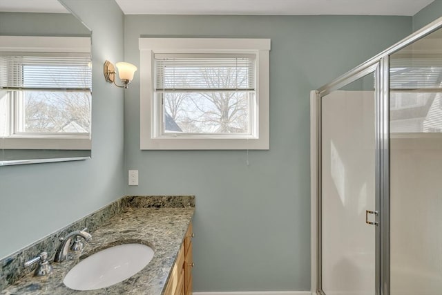 bathroom featuring vanity and a shower with shower door