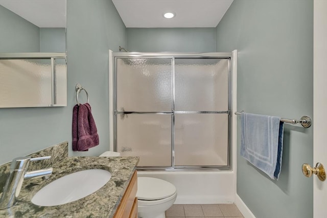 full bathroom featuring vanity, bath / shower combo with glass door, tile patterned floors, and toilet