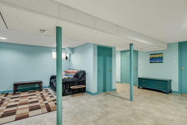 basement featuring a paneled ceiling