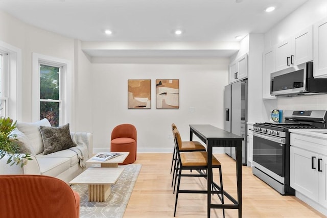 kitchen featuring light hardwood / wood-style floors, white cabinetry, and stainless steel appliances