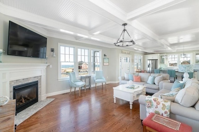 living room with a fireplace, hardwood / wood-style floors, beam ceiling, and ornamental molding