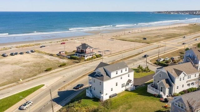 drone / aerial view featuring a water view and a beach view