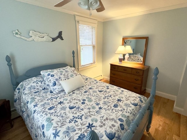 bedroom featuring crown molding, wood finished floors, baseboards, and ceiling fan