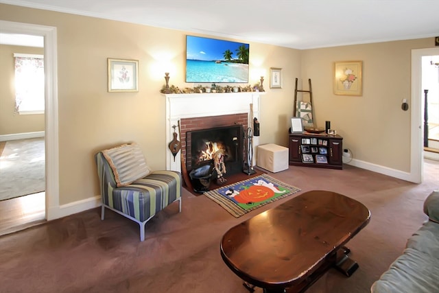 living room featuring crown molding, carpet flooring, and a fireplace