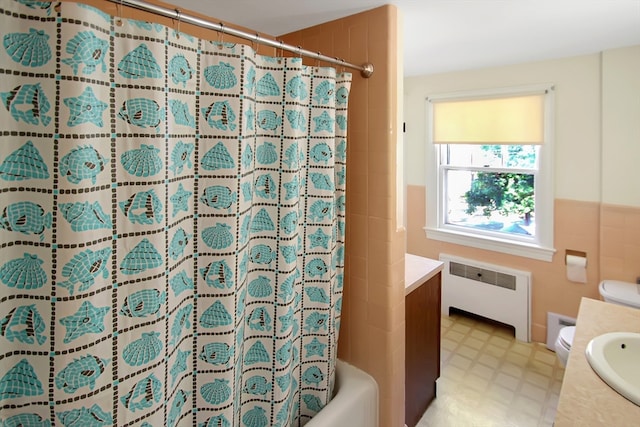 full bathroom featuring radiator, toilet, shower / bath combination with curtain, and vanity