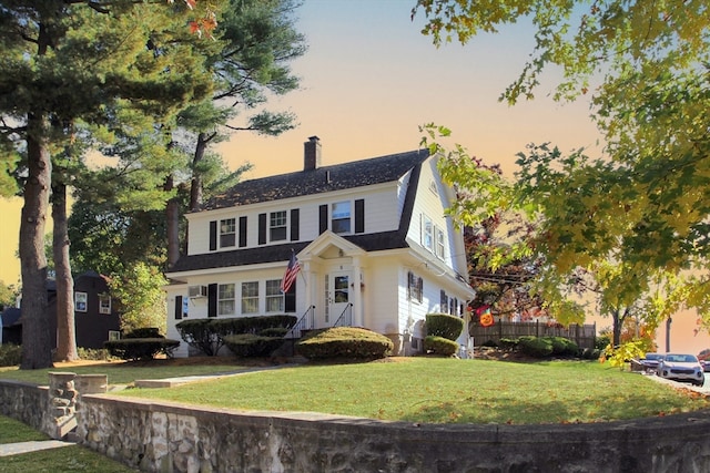 colonial inspired home with a yard