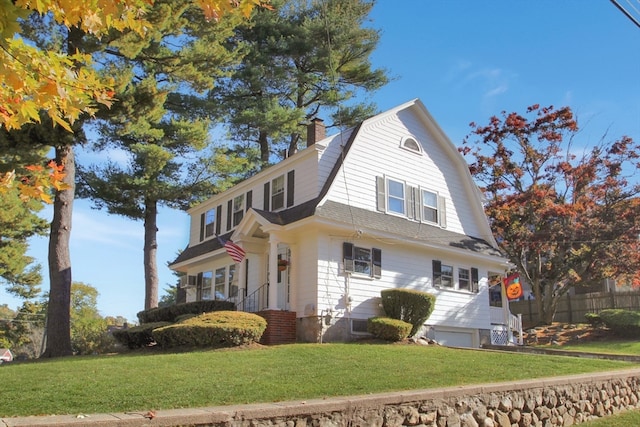 view of side of home featuring a garage and a lawn