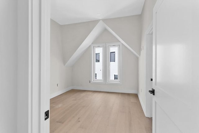 bonus room with light hardwood / wood-style flooring and vaulted ceiling