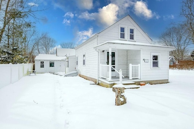 view of snow covered back of property