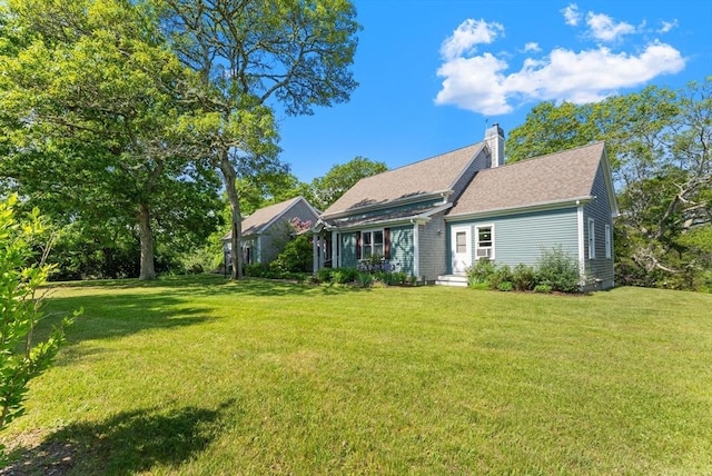 56 Bridle Path, Tisbury, MA 02567 - back of property with a chimney and a yard
