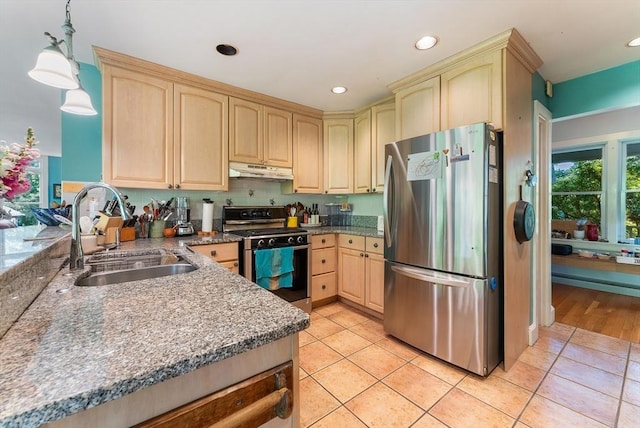 56 Bridle Path, Tisbury, MA 02567 - kitchen with stainless steel appliances, a sink, under cabinet range hood, light brown cabinetry, and light tile patterned floors