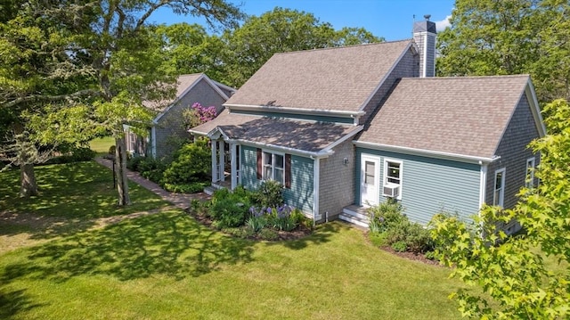 56 Bridle Path, Tisbury, MA 02567 - view of front of home featuring a chimney, a front yard, and a shingled roof