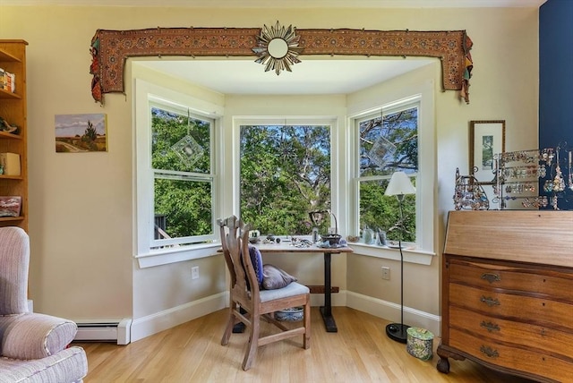 56 Bridle Path, Tisbury, MA 02567 - living area with a baseboard heating unit, light wood-style flooring, and baseboards