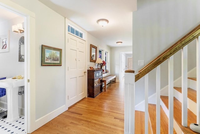 56 Bridle Path, Tisbury, MA 02567 - entryway featuring light wood finished floors, baseboards, and stairway
