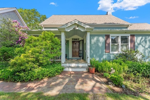 56 Bridle Path, Tisbury, MA 02567 - view of front of house with roof with shingles and a chimney