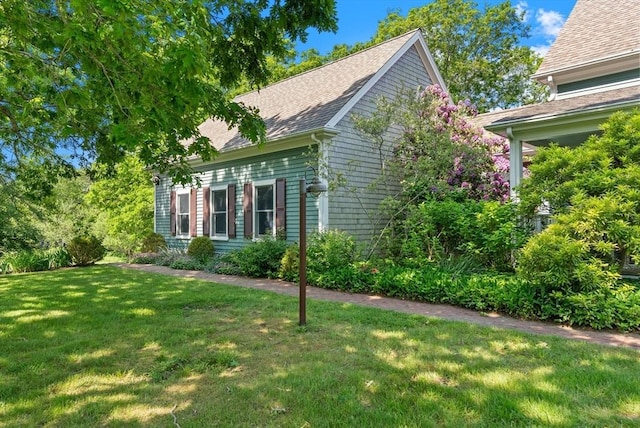 56 Bridle Path, Tisbury, MA 02567 - view of home's exterior with a lawn and a shingled roof