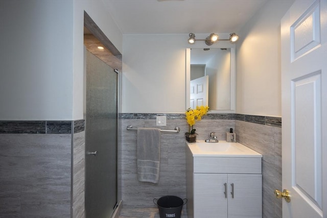 14 Adams Rd, Ashland, MA 01721 - bathroom with tile walls, vanity, wainscoting, and a shower with door