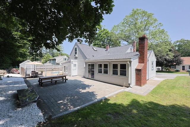 14 Adams Rd, Ashland, MA 01721 - rear view of property with a patio, a chimney, a shed, and a shingled roof