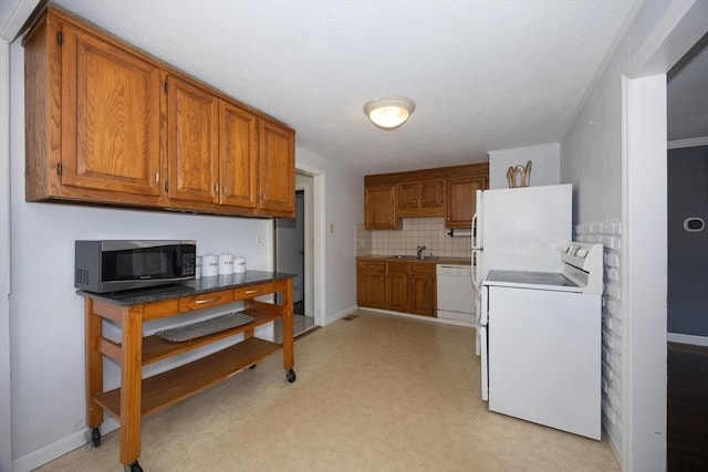 14 Adams Rd, Ashland, MA 01721 - kitchen with white appliances, brown cabinetry, and tasteful backsplash