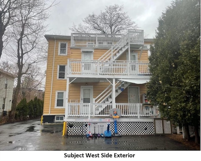 back of house featuring stairway