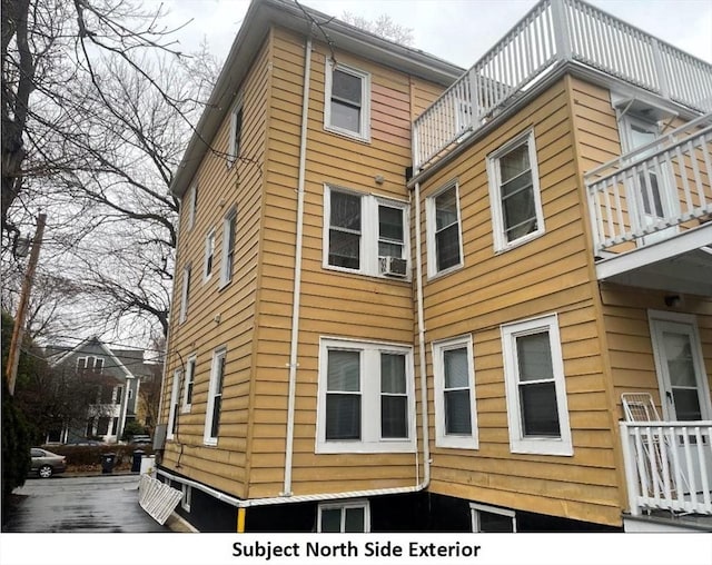view of home's exterior with a balcony
