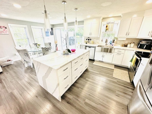 38 Thayer Ave, Whitman, MA 02382 - kitchen with stainless steel appliances, a sink, light wood-style flooring, decorative backsplash, and recessed lighting