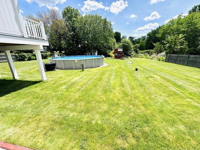 38 Thayer Ave, Whitman, MA 02382 - view of green lawn featuring a playground and an outdoor pool