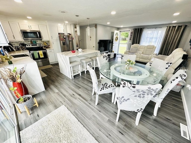 38 Thayer Ave, Whitman, MA 02382 - dining space with wood finished floors and recessed lighting