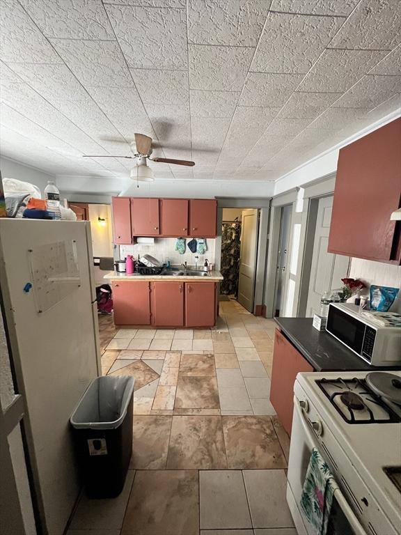 kitchen with ceiling fan, white appliances, and decorative backsplash