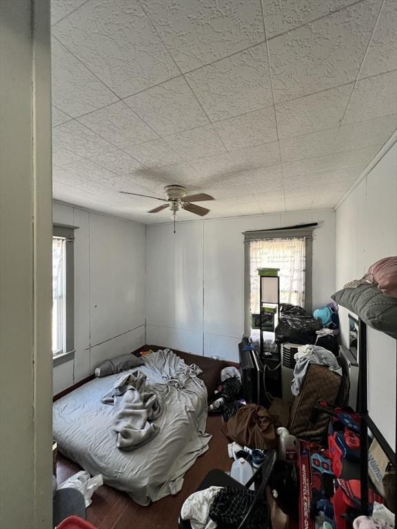 bedroom with ceiling fan and wood finished floors