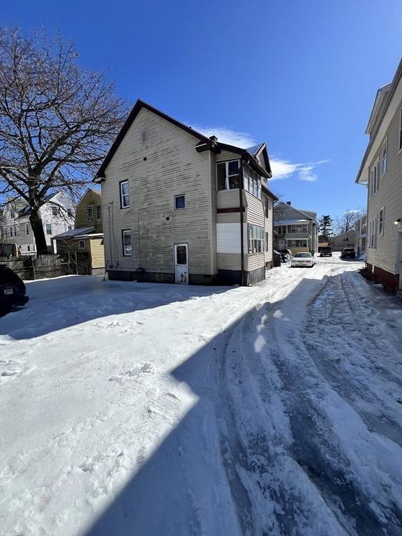 snow covered property with a residential view